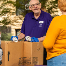Craig handing out food during Lunch on The Plaza