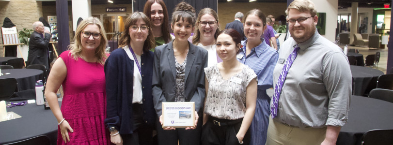 2025 Student Staff Member of the Year Jordan Fairchild (front center) is seen here with members of UPC staff. 